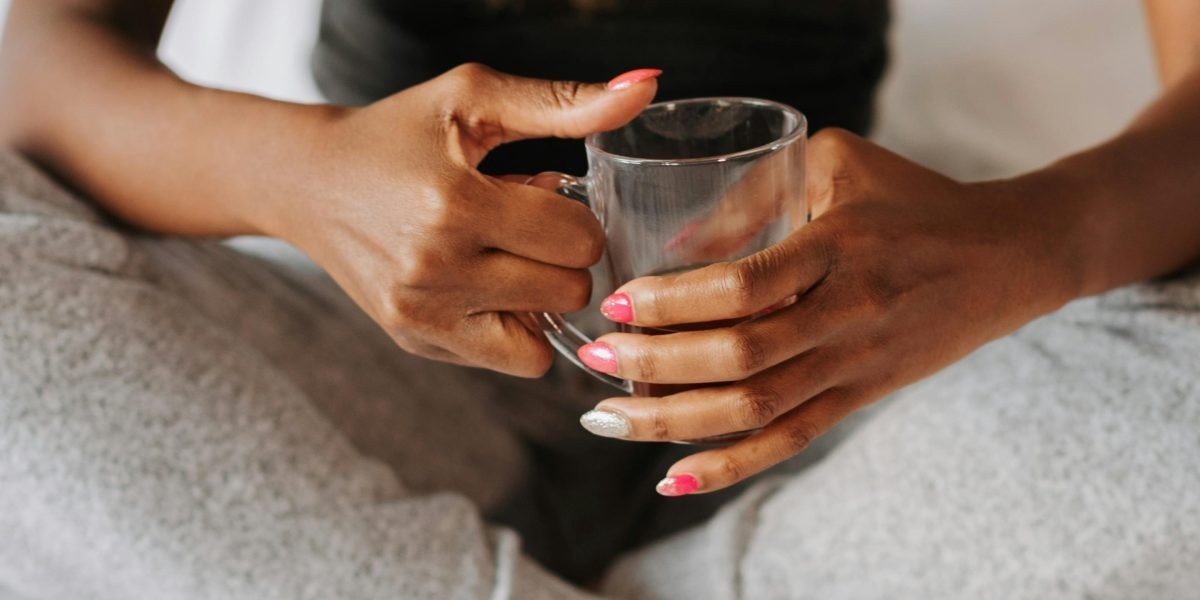 Close-up of hands holding a cup, implying self-care and reflection