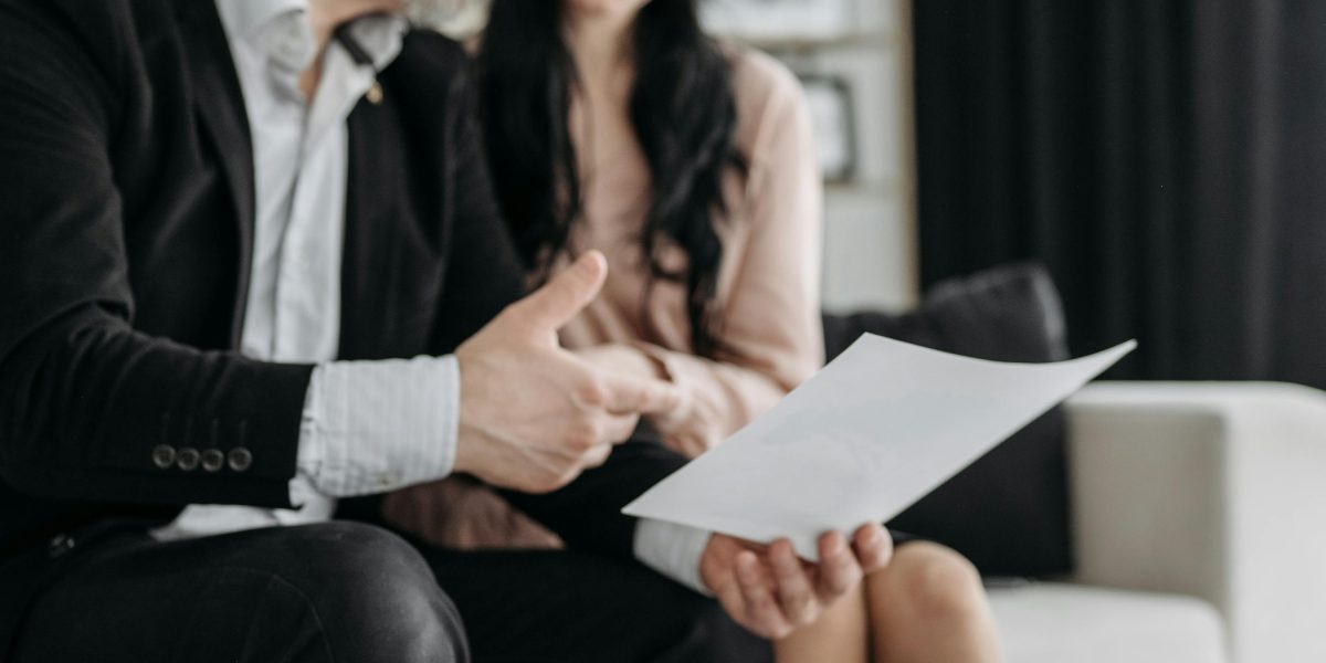 A caregiver offering support to a loved one, potentially assisting with health insurance paperwork or discussing care options.
