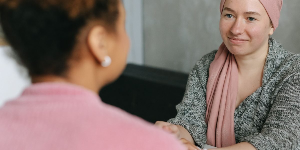 People engaged in a supportive and empathetic conversation, reflecting inclusive communication practices.