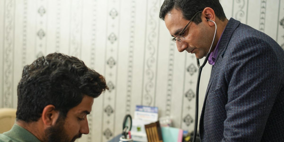 A medical professional actively listening to a patient, highlighting the importance of thorough clinical assessment.