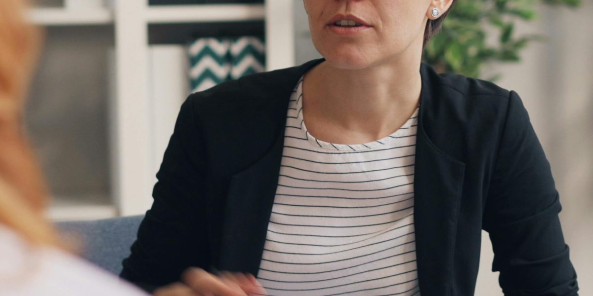 A person engaging in a supportive and trusting conversation during a therapy session.
