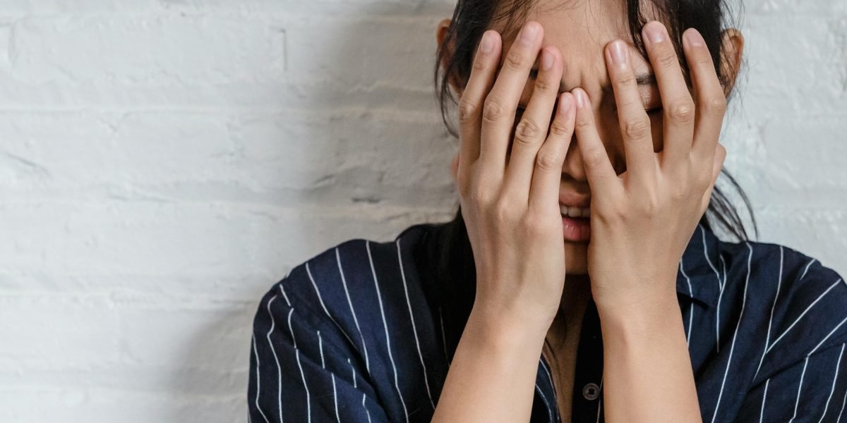 A person looking overwhelmed, representing the frustration of navigating complex systems when experiencing low mood.