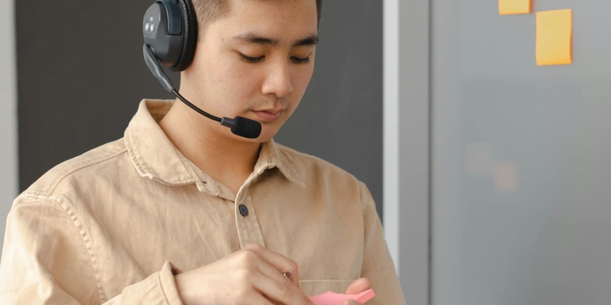 A person diligently preparing notes and documents before making an important phone call.