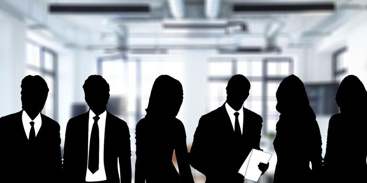 A diverse group of professionals working together, symbolizing the organized structure and collaborative efforts of state agencies in providing services.