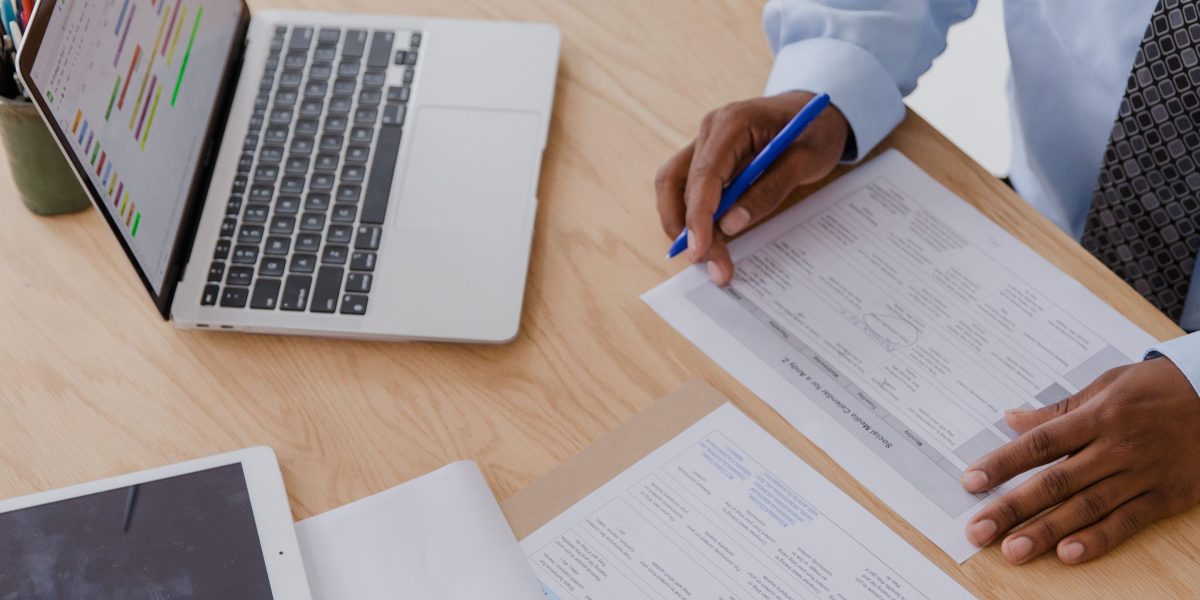 A person reviews insurance documents while on a phone call, symbolizing the effort to understand coverage.