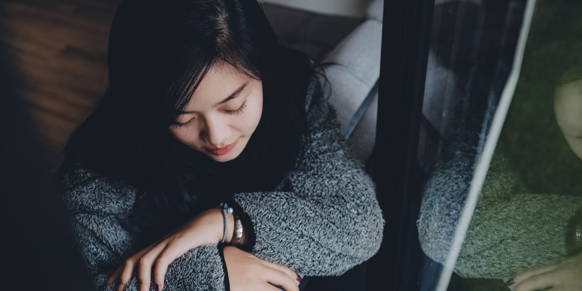 A person quietly reflecting, symbolizing the journey of understanding one's own mental health experiences.