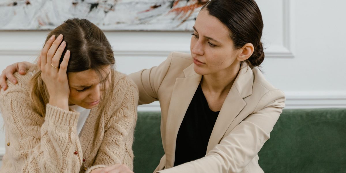 Two people engaged in a supportive conversation, illustrating the importance of understanding and communication in relationships.