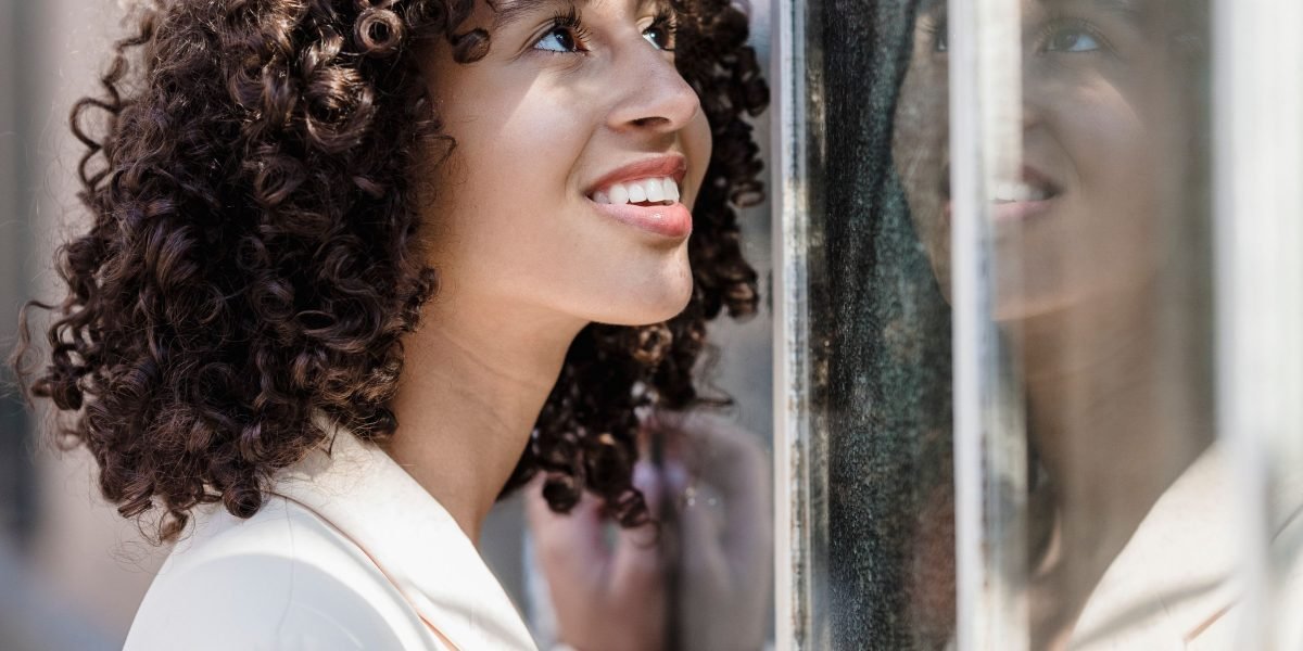 A person smiling confidently, embodying the positive outlook and resilience possible with effective management.
