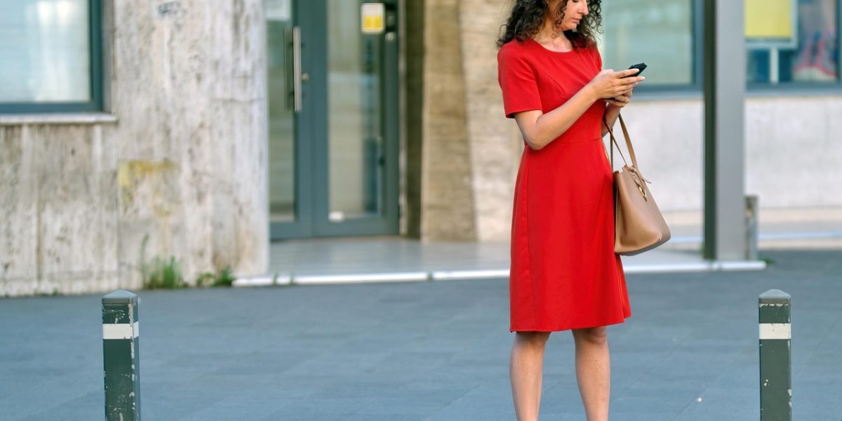 A person looking relieved or comforted while reading a message on their phone, depicting easy, secure communication with their care team.