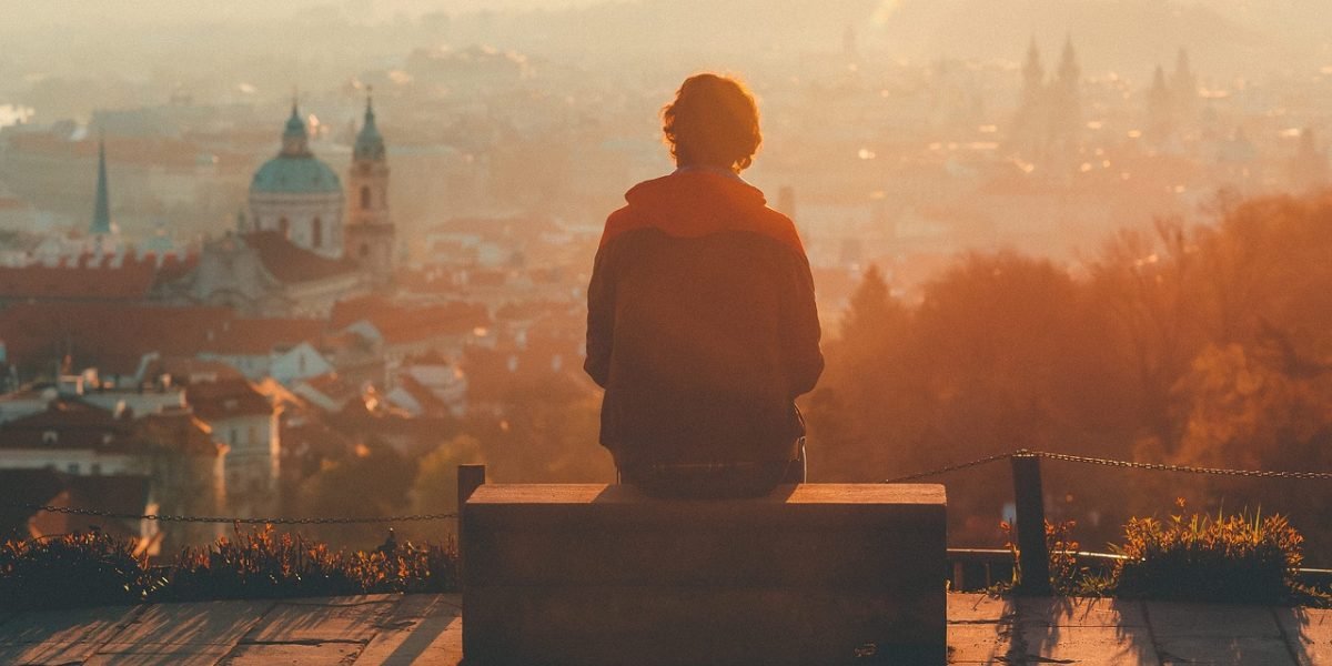 A person contemplating their feelings, wondering about the nature of their persistent low mood.