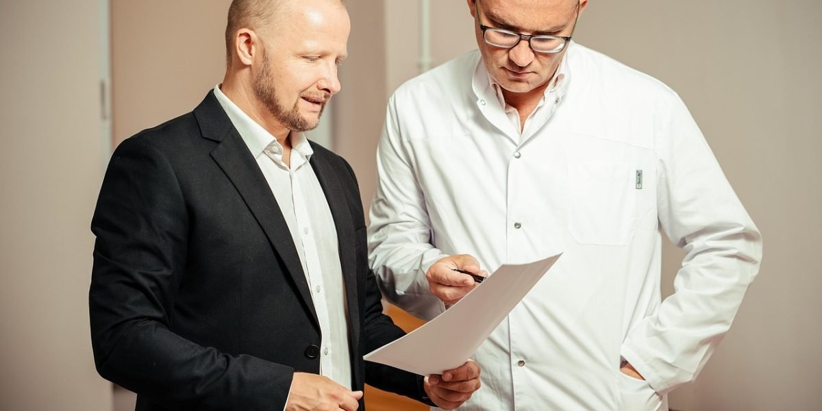 A healthcare provider and patient reviewing medical test results to rule out physical causes of symptoms.