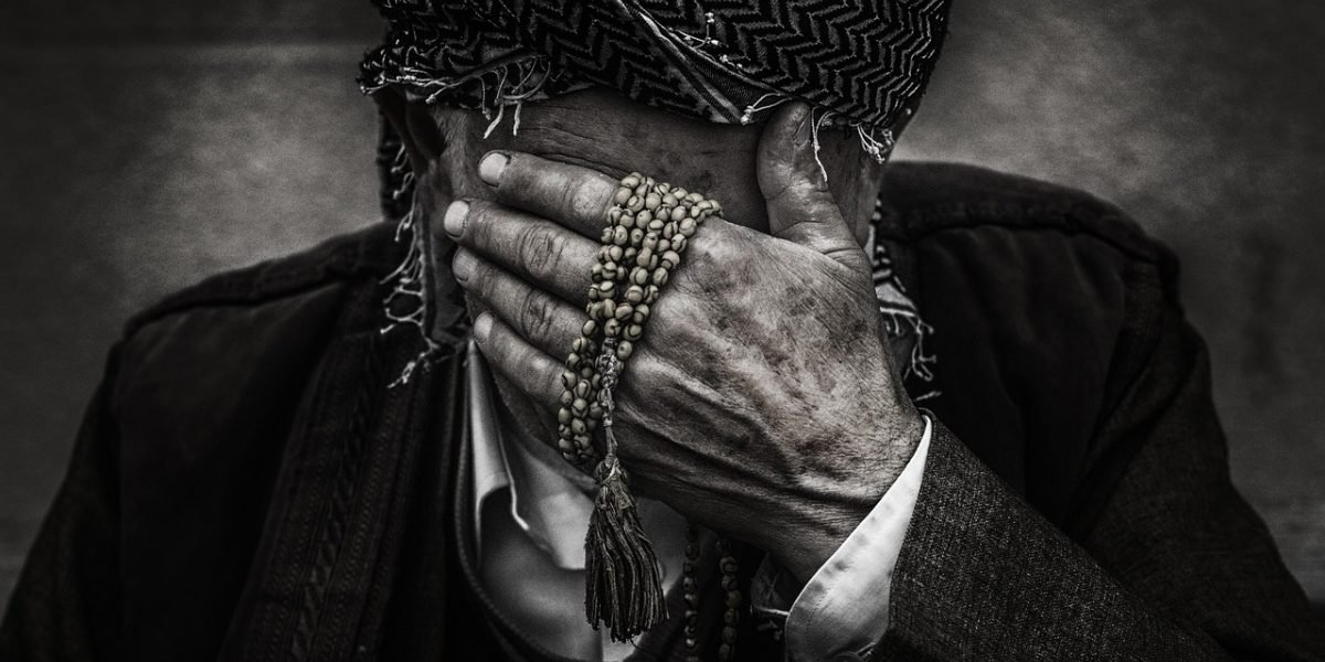 A person in professional attire maintaining a composed exterior while experiencing inner emotional struggle.