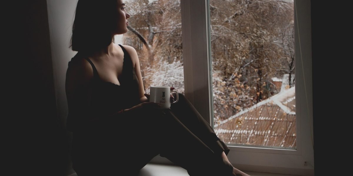A person in thoughtful contemplation, reflecting on their feelings or choices regarding mental health care.