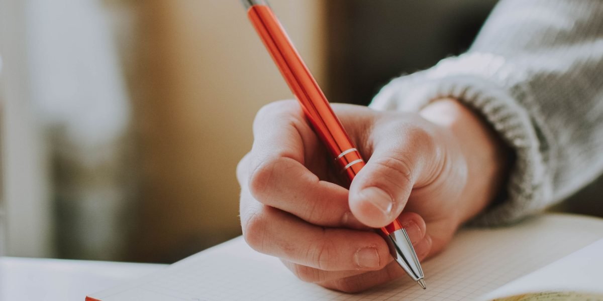A person confidently preparing, writing down notes, feeling ready and empowered for their first appointment.