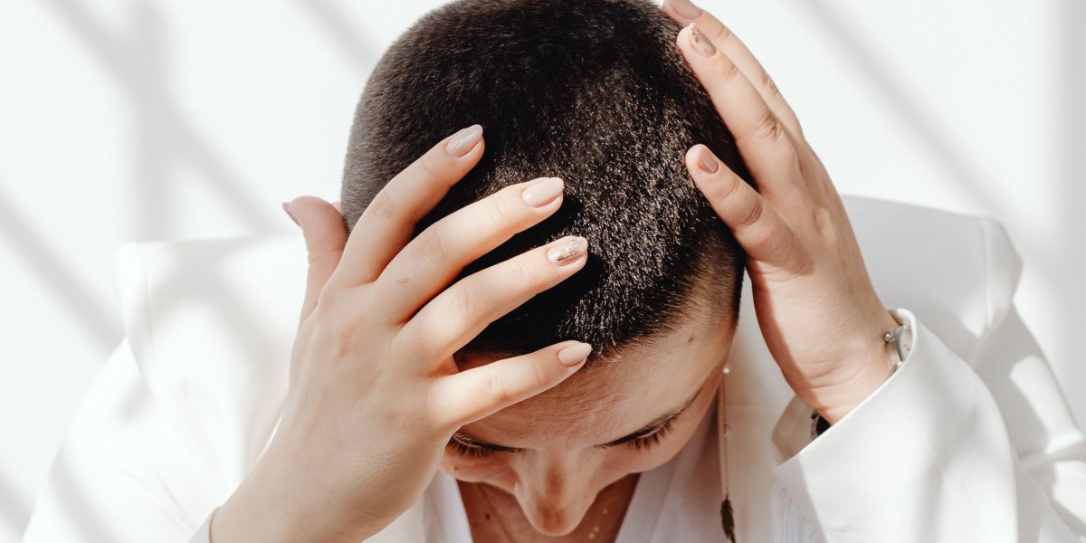 A person looking thoughtful and slightly overwhelmed, reflecting the mental burden of constant stress.