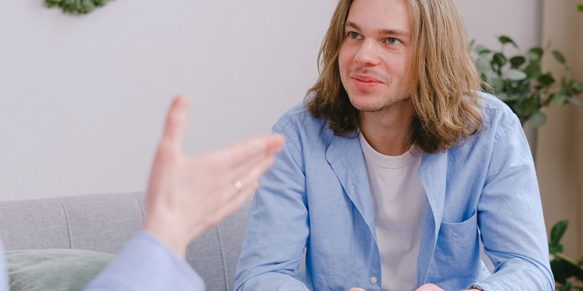 A person engaged in a conversation with a therapist, showing a moment of connection and support.