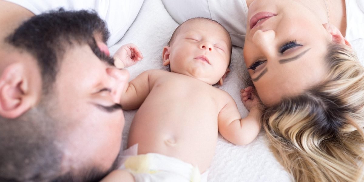 A family sits together, engaging in a conversation with a counselor, representing family therapy.