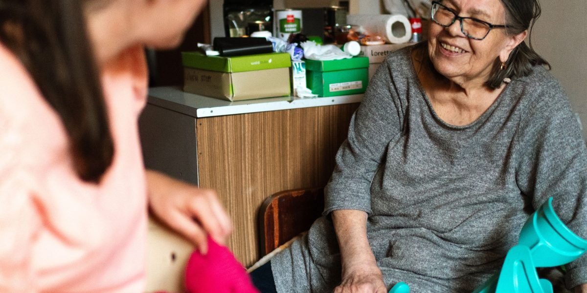 A caregiver provides support to a family member, helping them navigate and understand their health information securely.