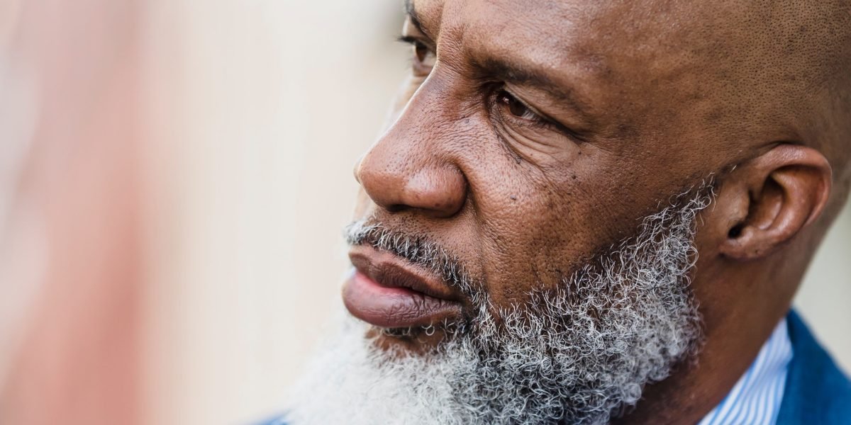 An older veteran reflects, representing the lasting impact of service and the ongoing need for mental health support.